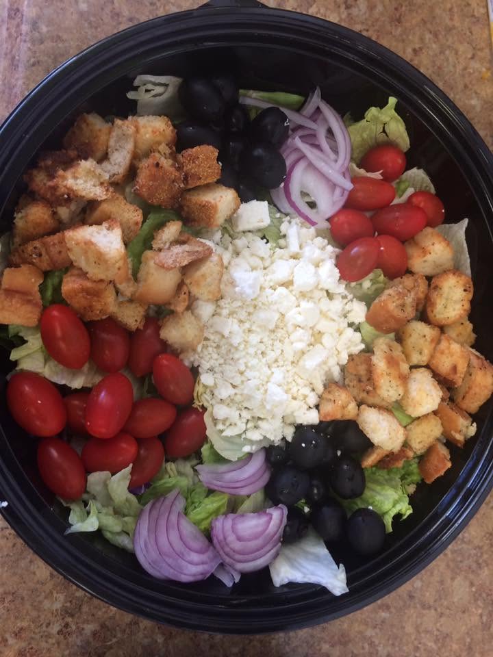 Greek salad with tomatoes, olives, red onion, feta and croutons